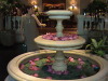 Carol admires the flowers at Bangkok Hotel